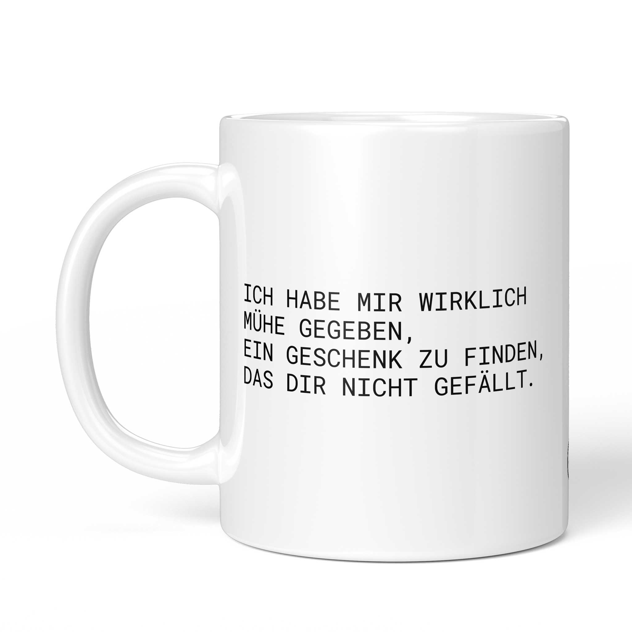 Rückseite der Brüllerware Tasse "Ich habe mir wirklich Mühe gegeben, ein Geschenk zu finden, das dir nicht gefällt." mit Logo - Spülmaschinenfest & Mikrowellengeeignet