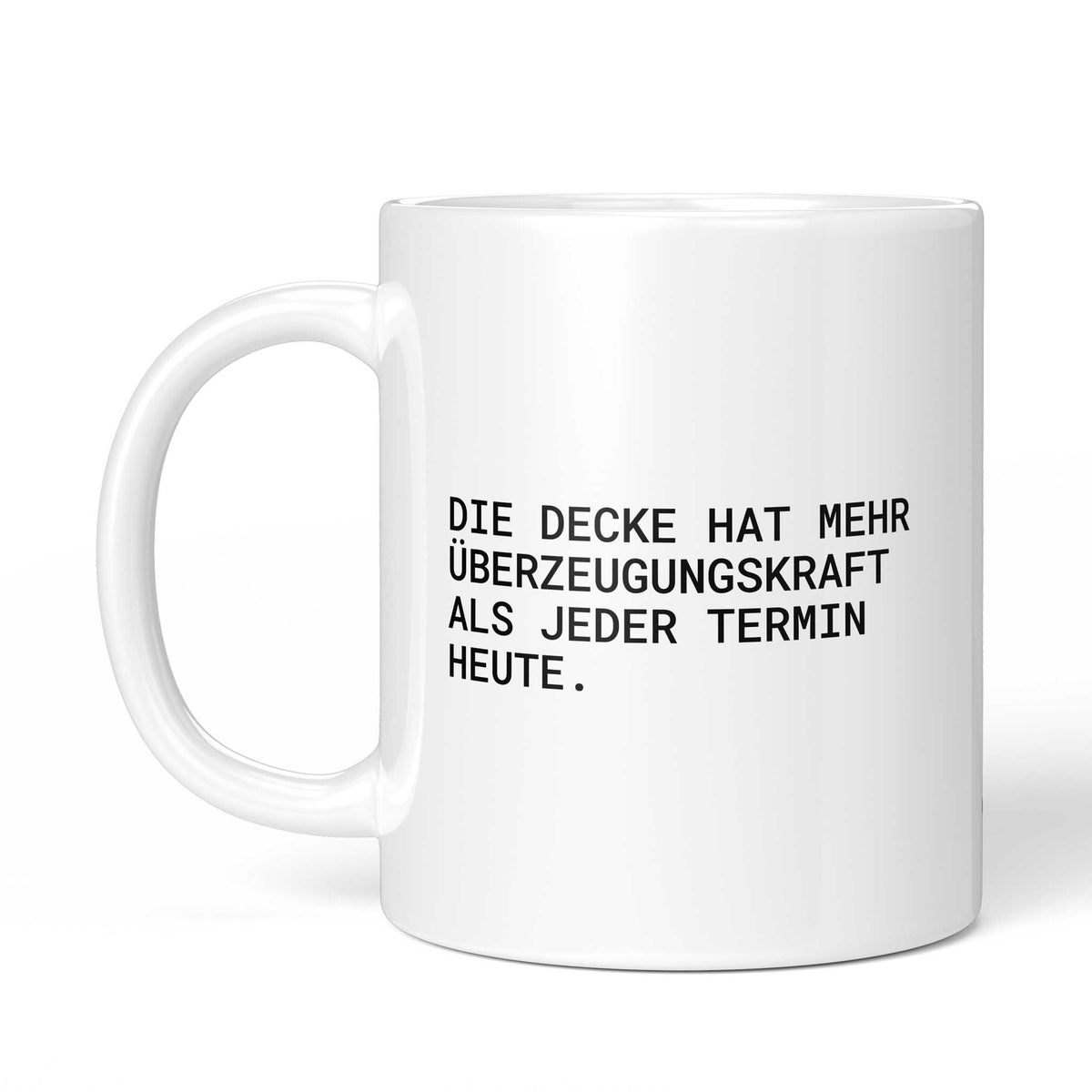 Weiße Tasse „Die Decke hat mehr Überzeugungskraft“ mit Henkel links