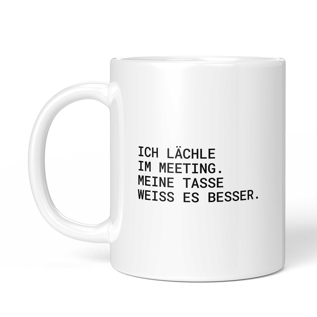 Weiße Tasse „Ich lächle im Meeting. Meine Tasse weiß es besser“ mit Henkel links
