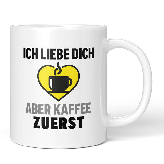 Mug front: “I love you – but coffee first” with heart