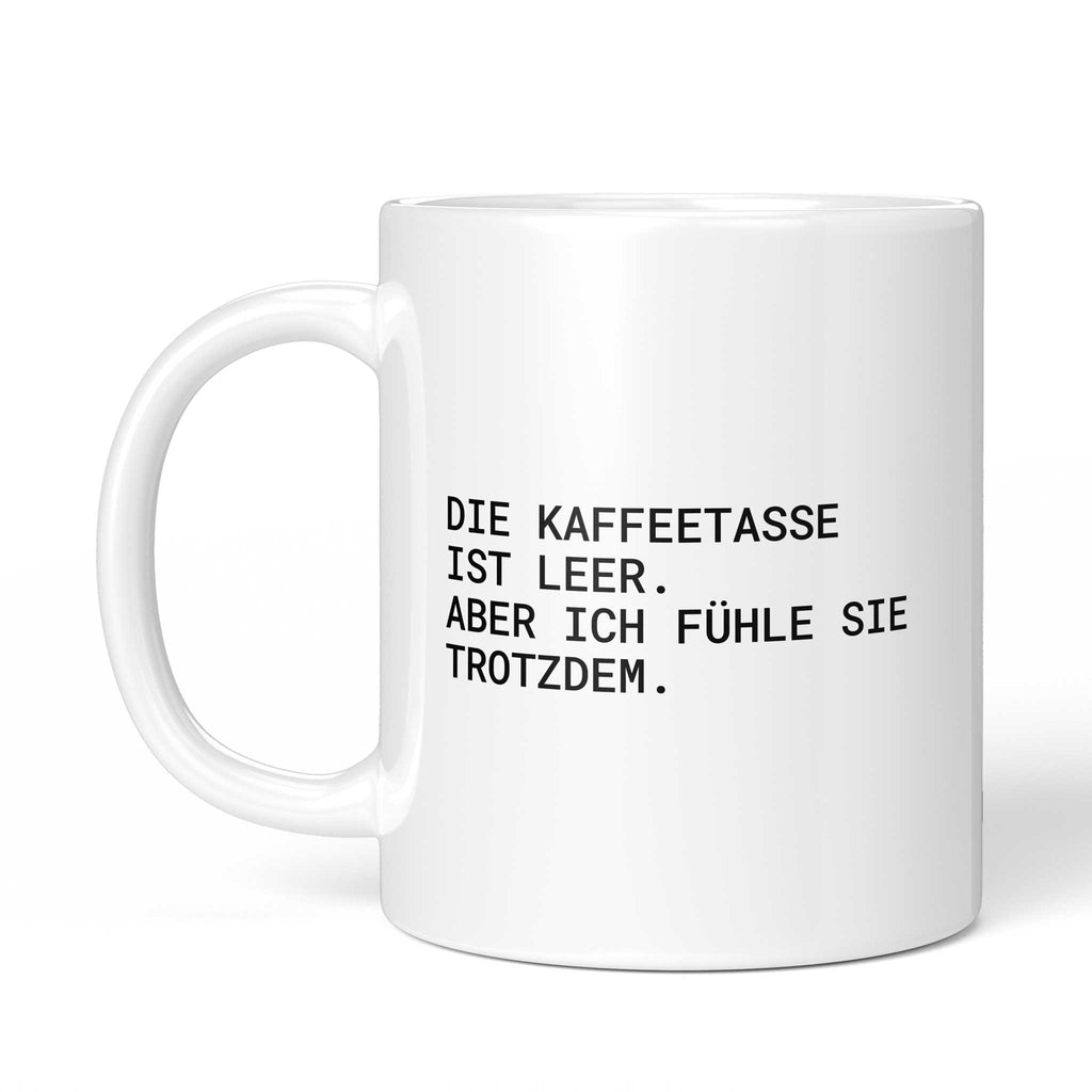 Tasse „Die Kaffeetasse ist leer – aber ich fühle sie trotzdem.“ – Ansicht mit Henkel links
