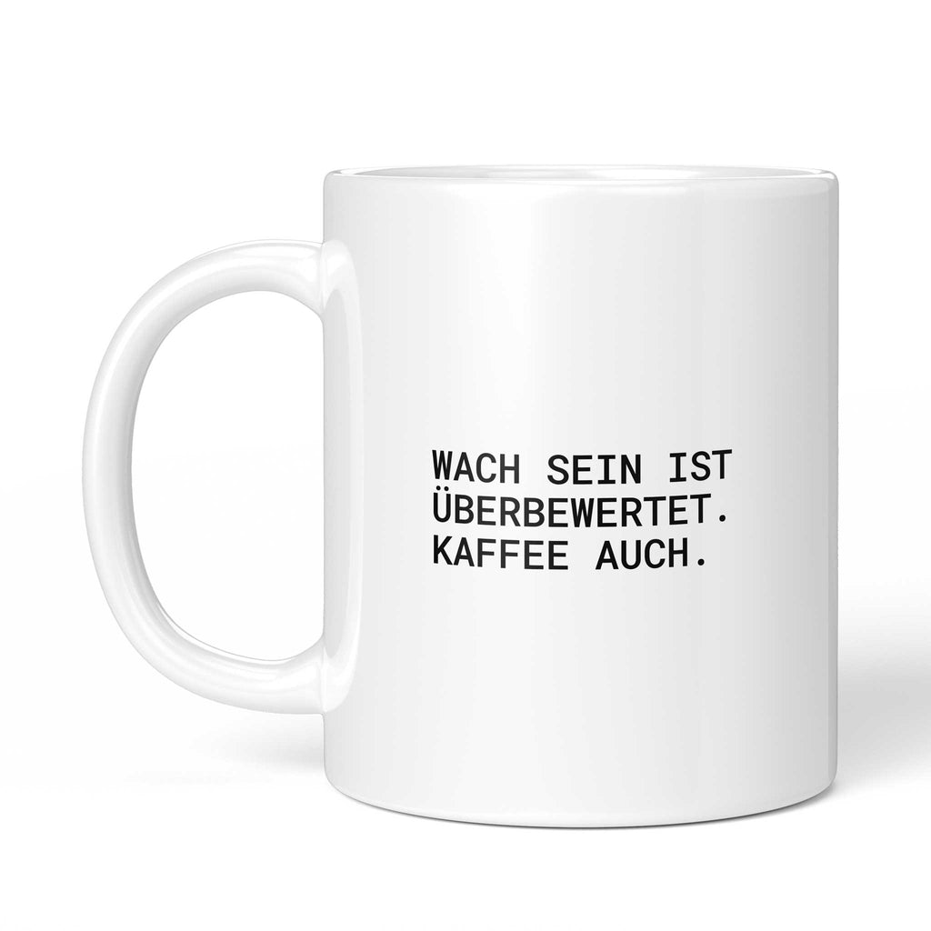 Tasse „Wach sein ist überbewertet. Kaffee auch.“ – Ansicht mit Henkel links