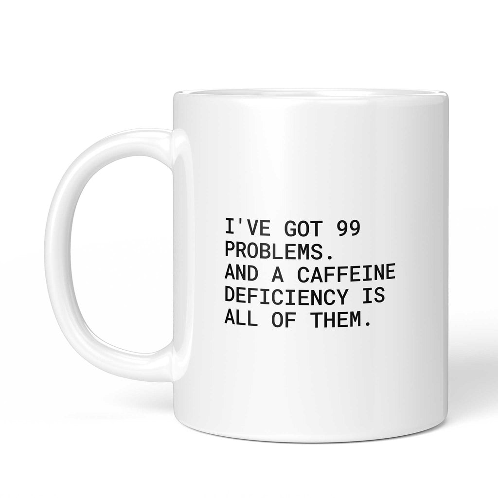 Weiße Tasse „I’ve got 99 problems – and a caffeine deficiency“ mit Henkel links
